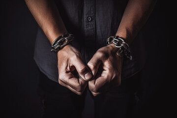 Male hands in handcuffs. Criminal problems and violence concept. Serving justice. Generative AI - obrazy, fototapety, plakaty