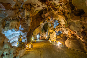 The Buddha statue is situated in the cave at Wat Khao Tham Ma Rong, Bang Saphan, Prachuap Khiri Khan, Thailand