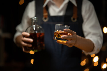 Barman pouring whiskey whiskey glass beautiful night