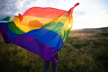Young woman with LGBT flag. - obrazy, fototapety, plakaty