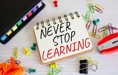 Never stop learning symbol. Concept words Never stop learning on wooden notebook. Beautiful wooden background. Business and Never stop learning concept. Copy space.