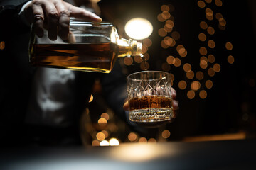 Barman pouring whiskey whiskey glass beautiful night