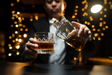Barman pouring whiskey whiskey glass beautiful night