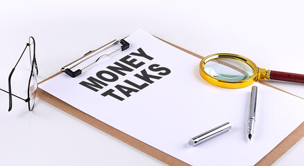 MONEY TALKS text on clipboard on white background, business concept