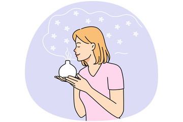 Young woman smell fragrance from aromatherapy diffuser