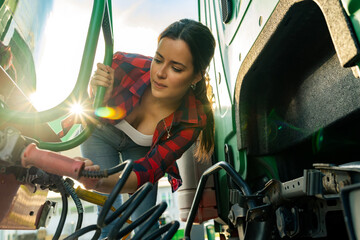 female junior driver checks the truck's equipment, practices safe driving and follows safety...