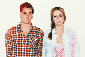 Portrait of hipster couple, serious face and gen z fashion with university culture in youth. Trendy students, woman and man in instant picture on college date, cool people on white wall background.