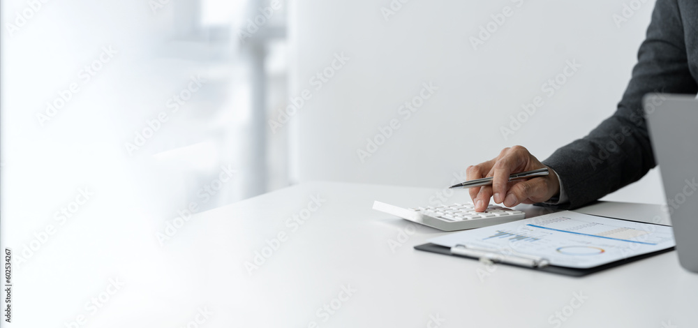 Poster copy space, banner, panorama businessman working on desk using calculator to calculate numbers and d