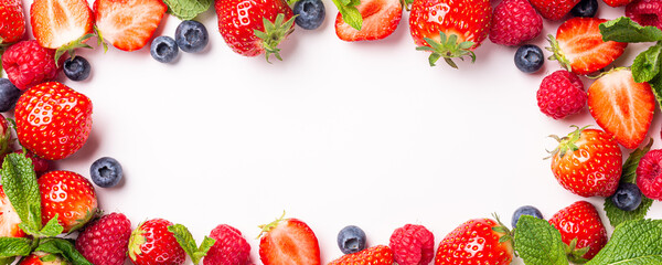 Frame banner made of fresh strawberry, raspberry and blueberry on white background, top view, flat lay. Creative food concept with copy space