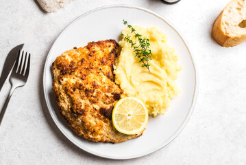 Schnitzel or breaded chop with mashed potatoes