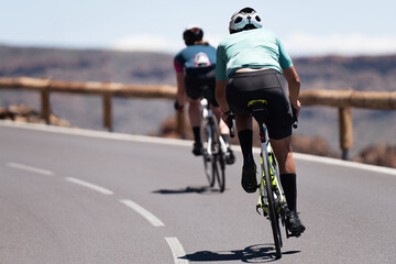 Man and woman couple road cycling on race bike outdoor in nature