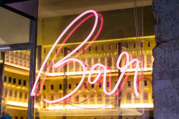 Neon sign with the word bar in rose.