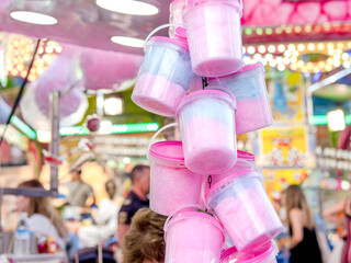 Cotton candy canisters hung at the fair. Selective focus.