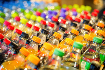 Colored plastic bottles with carbonated sweet drinks.