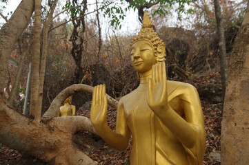 Golden Standing Buddha enshrined on the Phou Si mountain at Wat Thamothayaram temple. Which is the way to Wat Phra That Phou Si temple. Located Luang Prabang Province in Northern of Laos.