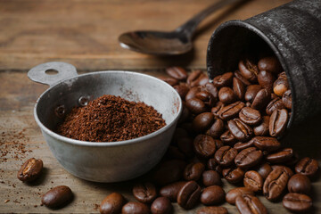 Ground coffee in a cup and roasted coffee beans in a tin