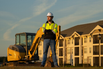 Builder in helmet on the construction site.