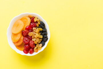 Bowl with different dried fruits on table background, top view. Healthy lifestyle with copy space