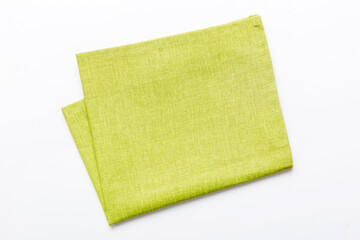 top view with green kitchen napkin isolated on table background. Folded cloth for mockup with copy...