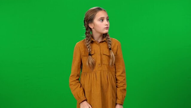 Curious girl with hand at ear listening gossip shaking head with disapproval crossing hands looking at camera. Portrait of nosey Caucasian teenager posing at chroma key background