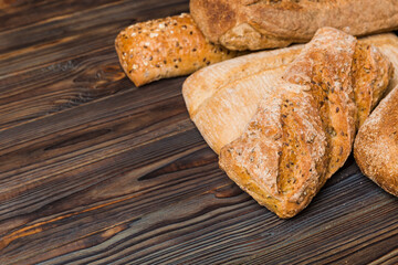 Homemade natural breads. Different kinds of fresh bread as background, perspective view with copy space