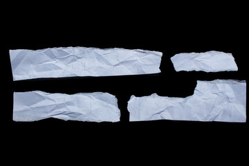 Set of ripped piece of white paper isolated on black background. Crumpled paper.