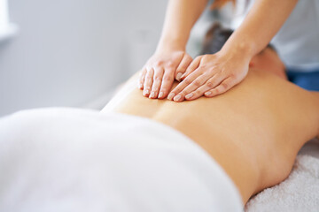 Obraz na płótnie Canvas Brunette woman having back massage in salon