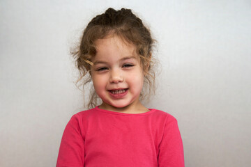 Cute little girl portrait on a grey background