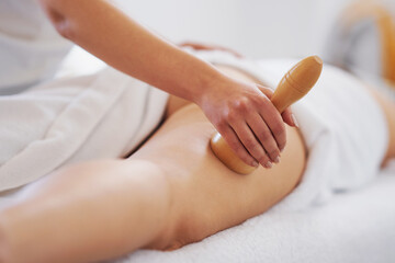 Woman at massage therapy with wooden tools