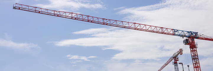 Tower cranes building a house. Concrete building under construction. Construction site