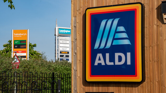 Aldi supermarket Exterior signage with competitor Sainsbury's in the background, 3rd May 2023, Leamington Spa, UK