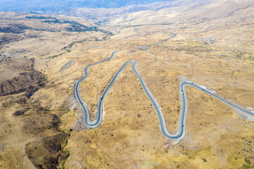Aerial view of hairpin road nearby Vorotan Pass and Syunik Gate on sunny autumn day. Vayots Dzor Province, Armenia.