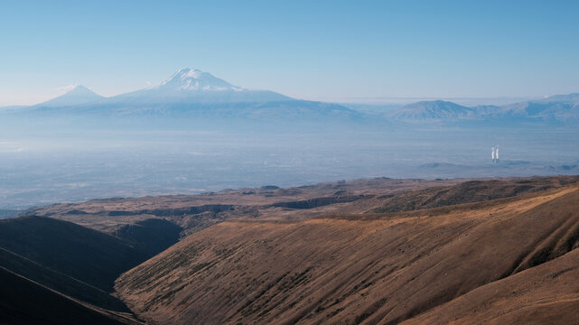 View of Mount Ararat and Metsamor Nuclear Power Plant from Mount Aragats on sunny autumn day. Aragatsotn Province, Armenia.