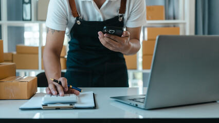 Asian business man seller freelancer prepares box for delivery to  customer in sme supply chain,...