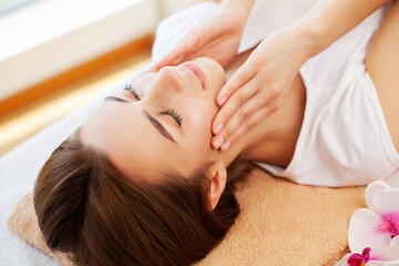 Obraz na płótnie Canvas Close-up of young woman getting spa massage treatment at beauty spa salon.