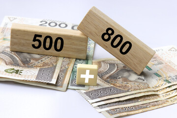 Inscription 800 and 500 plus on wooden blocks with 500 PLN and 800 polish zloty and plus sign. 800...
