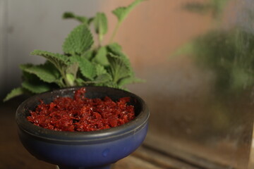 bowl of tobacco for hookah. smoking nargile. berries and fruits on a dark background