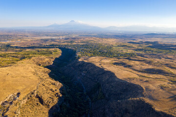 Drone view of Amberd canyon and Mount Ararat on sunny autumn day. Armenia.