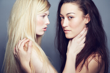 Face, portrait and beauty of women couple in studio for makeup, cosmetics and lgbtq lifestyle. Seductive gay or lesbian people together on a grey background for self love, skin care and natural glow