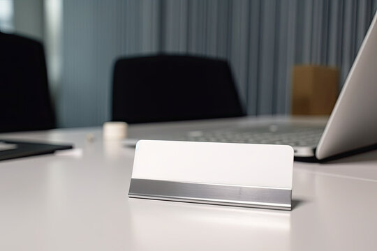 Close up of white empty name plate in office on desk on background of laptop. Free space for writing the name of the department, position, name of the head or employee. Generative AI