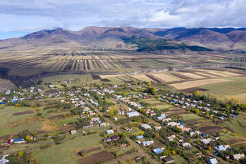 Fototapeta na wymiar Aerial view of Amrakits (former Nikolaevka) village on sunny autumn day. Lori Province, Armenia.