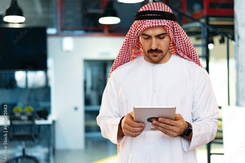 Wall mural arab muslim businessman using digital tablet in modern office