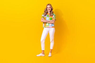 Full length photo of charming confident lady wear flower print t-shirt smiling arms crossed isolated yellow color background