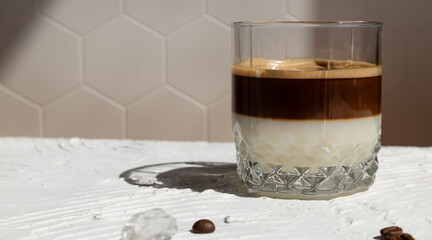 Making Bonbon coffee. Coffee made from boiled condensed milk, ice and espresso in a glass glass....