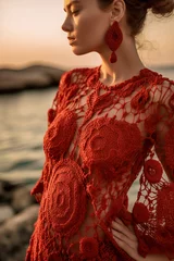 Poster Radiant Red: A Beautiful Woman in a Summer Knit Dress Watching the Sunset at the Beach, ai generative © larrui