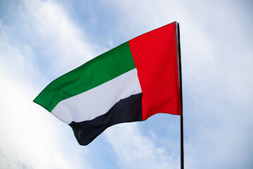 Waving fabric texture of the flag with color of United Arab Emirates, UAE real texture flag