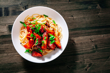 Spaghetti pasta with fried pork in bowl
