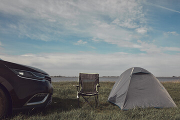 Camping in nature, unpacking and packing small tent outdoors, recreation and hobbies.