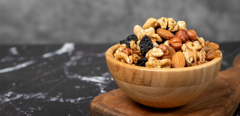 Mixed raw nuts. Special mixed nuts in bowl. Hazelnut, almond, cashew, pistachio, dried blueberry. Superfood. Vegetarian food concept. healthy snacks. Copy space