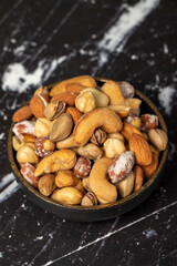 Mixed nuts. Special mixed nuts in bowl. Hazelnut, almond, cashew, pistachio, dried blueberry. Superfood. Vegetarian food concept. healthy snacks. Close up
